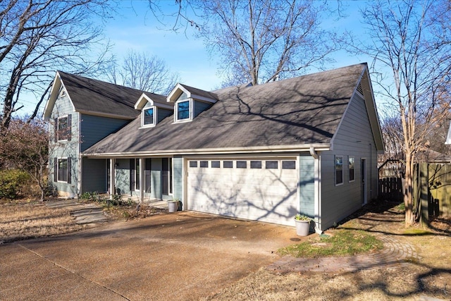 cape cod-style house featuring a garage