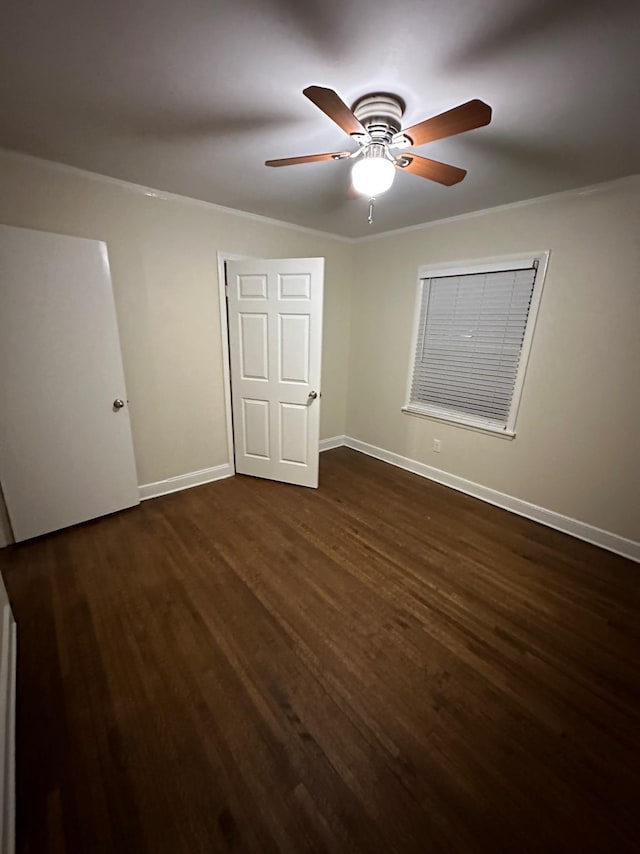 unfurnished bedroom featuring ceiling fan and dark hardwood / wood-style floors