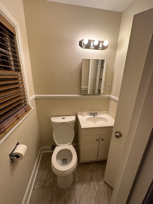 bathroom featuring toilet and vanity