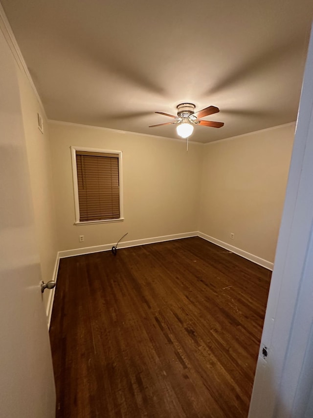 spare room featuring ceiling fan, dark hardwood / wood-style flooring, and ornamental molding