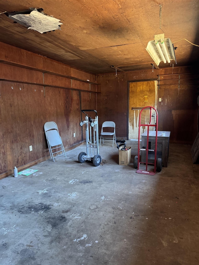 garage with wooden ceiling and wooden walls