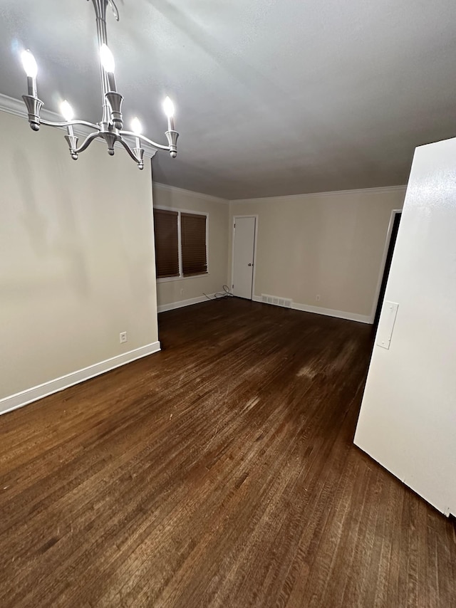 unfurnished dining area with a chandelier and dark hardwood / wood-style floors