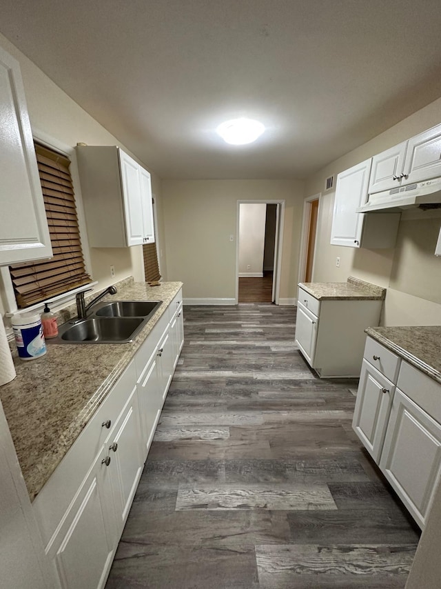 kitchen featuring sink, white cabinetry, and dark wood-type flooring