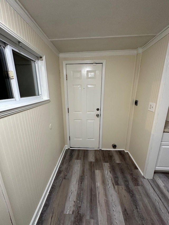 entryway featuring dark wood-type flooring and ornamental molding