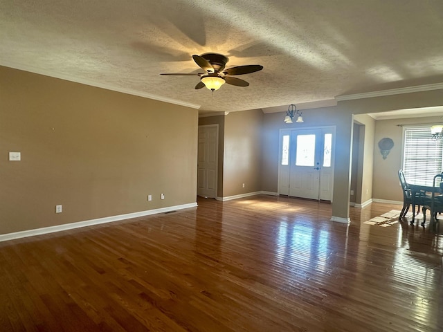 unfurnished room with dark hardwood / wood-style flooring, ceiling fan with notable chandelier, crown molding, and a textured ceiling