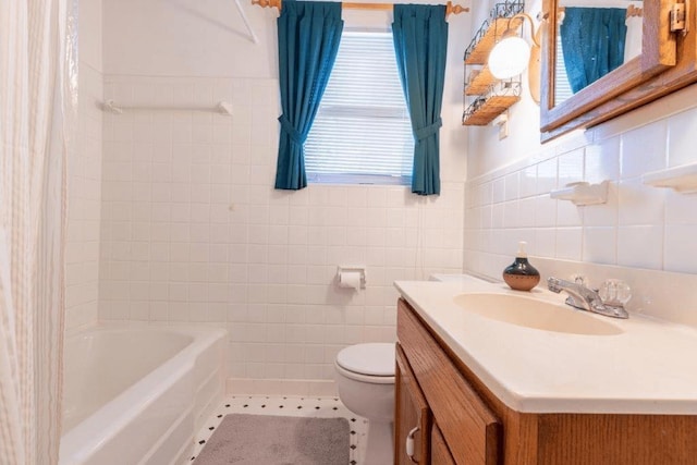 bathroom with toilet, tile walls, tile patterned floors, and vanity