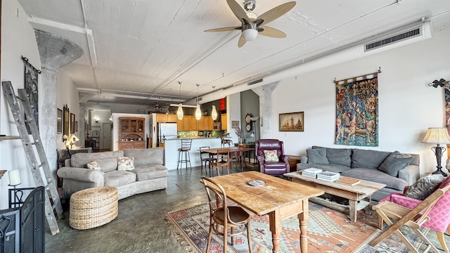 living room with ceiling fan and decorative columns