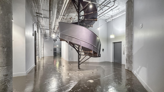 hallway featuring a towering ceiling