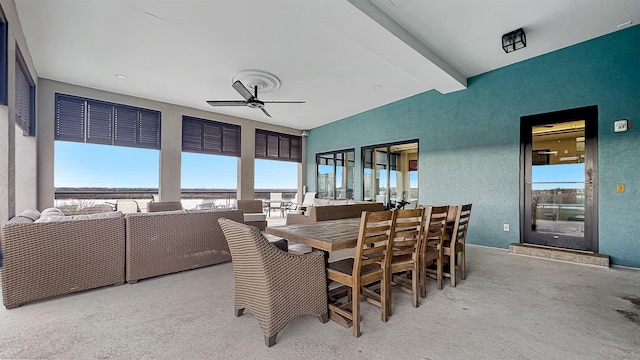 dining room featuring ceiling fan and beamed ceiling