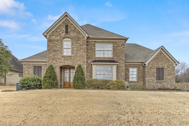 view of front of home with a front lawn and french doors