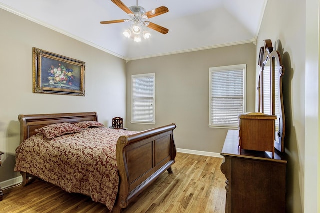 bedroom with crown molding, vaulted ceiling, light hardwood / wood-style floors, ceiling fan, and multiple windows