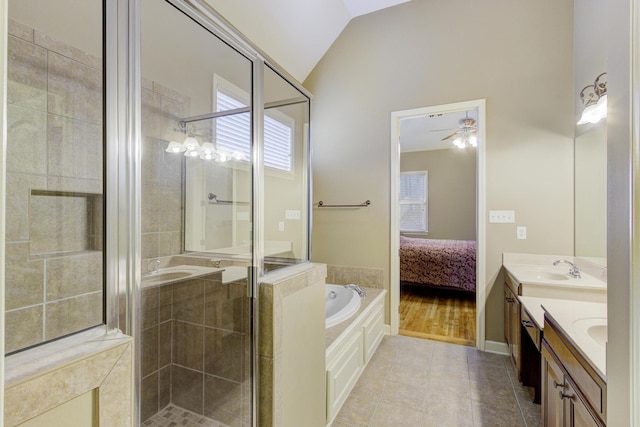 bathroom with separate shower and tub, tile patterned flooring, lofted ceiling, and vanity