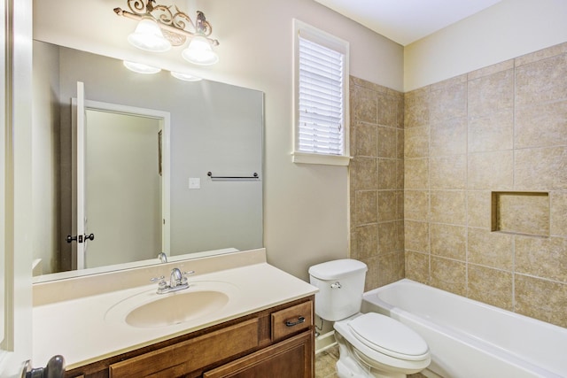 full bathroom featuring vanity, toilet, and tiled shower / bath