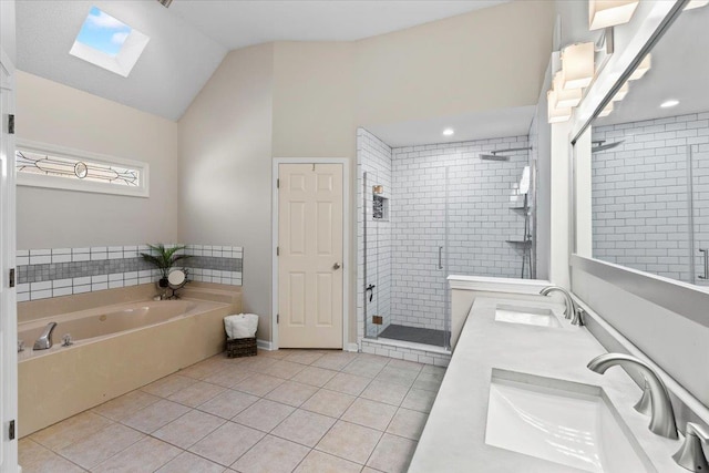 bathroom featuring vanity, lofted ceiling with skylight, tile patterned floors, and separate shower and tub