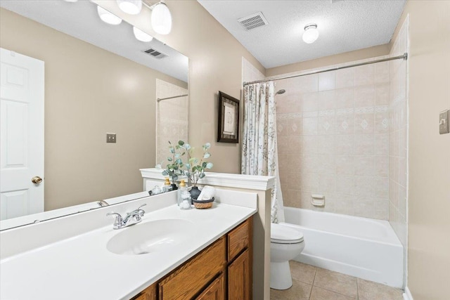 full bathroom with a textured ceiling, tile patterned floors, vanity, toilet, and shower / tub combo with curtain