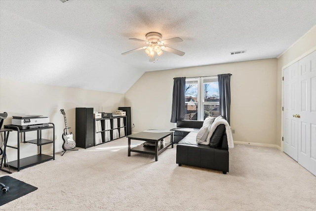 living area with ceiling fan, light colored carpet, a textured ceiling, and lofted ceiling