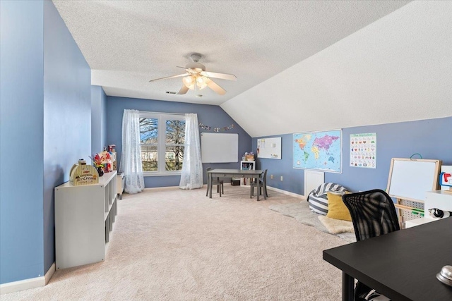 carpeted office space with ceiling fan, a textured ceiling, and lofted ceiling