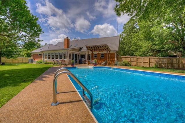 view of pool with a yard