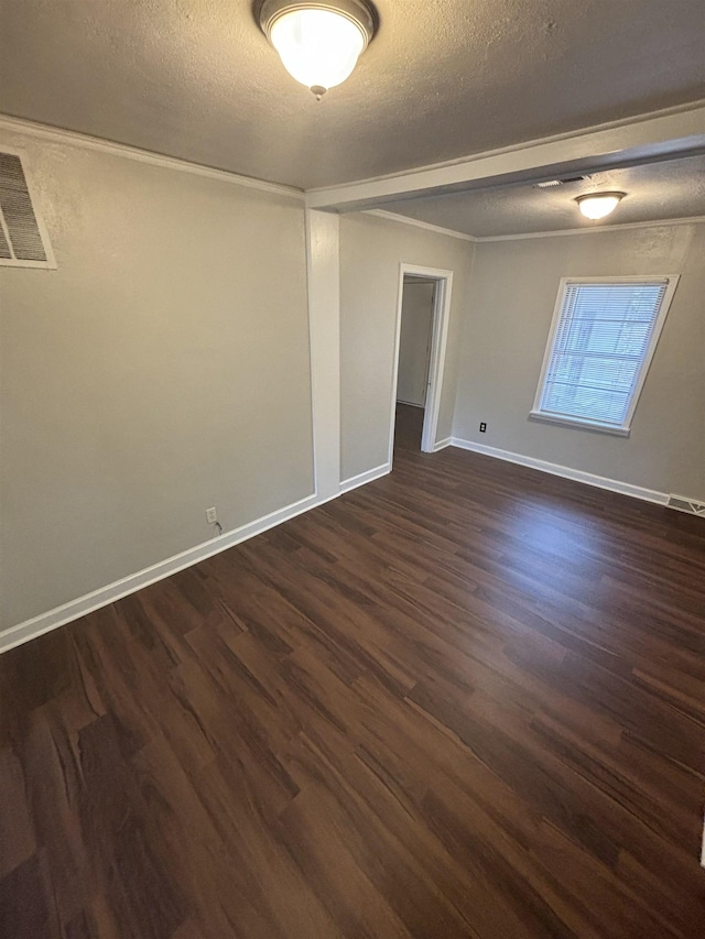 spare room featuring dark wood-type flooring and a textured ceiling