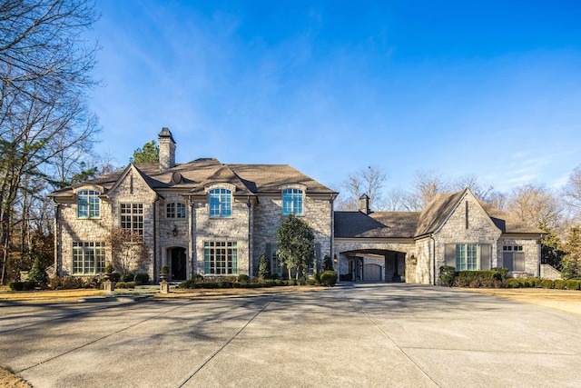 french country inspired facade featuring a carport