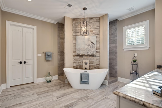 bathroom with ornamental molding, a chandelier, a tub to relax in, and vanity