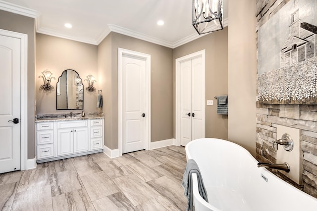 bathroom featuring vanity, a bathtub, crown molding, and an inviting chandelier