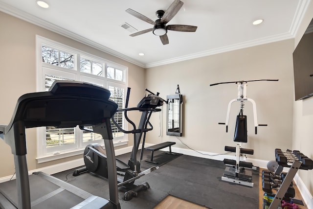 workout area featuring ceiling fan and ornamental molding