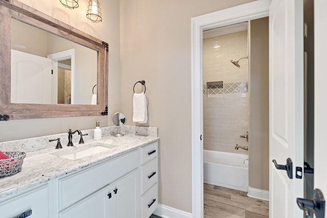 bathroom featuring vanity and tiled shower / bath combo