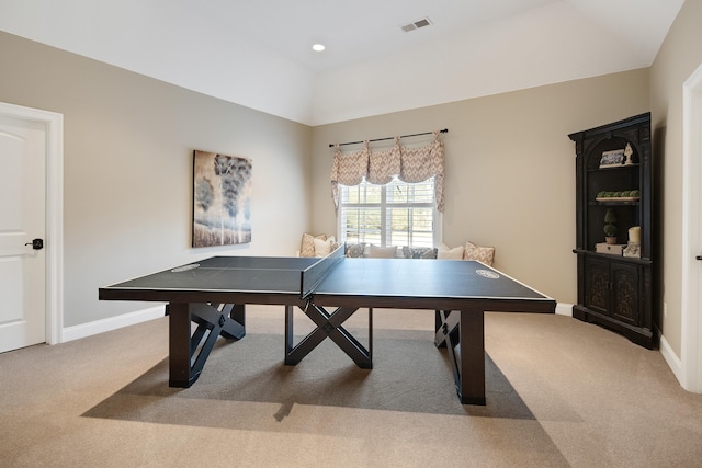 rec room with light carpet and a tray ceiling