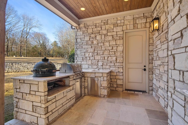 view of patio featuring sink, an outdoor kitchen, and area for grilling