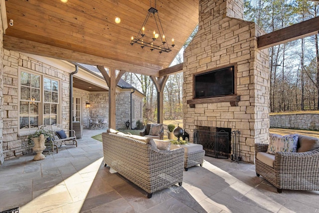 view of patio with an outdoor living space with a fireplace