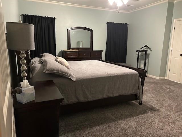 bedroom with dark carpet and crown molding