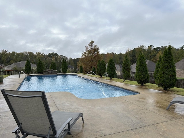 view of swimming pool with pool water feature and a patio