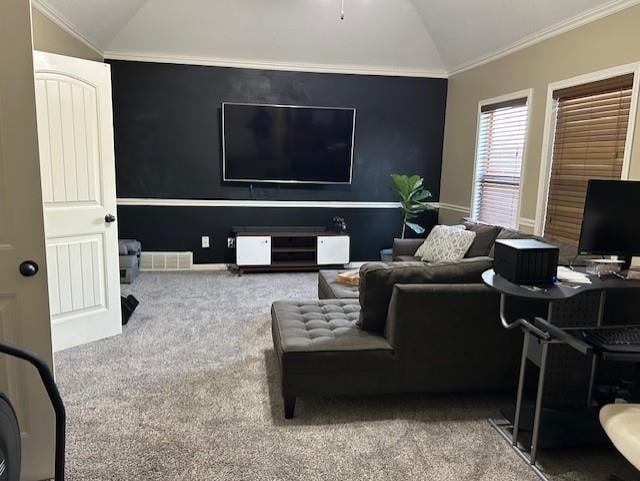 carpeted living room with crown molding and vaulted ceiling