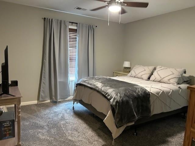 bedroom with ceiling fan, multiple windows, and dark colored carpet