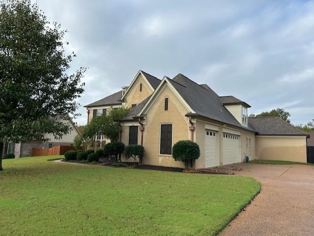 view of front of home featuring a garage and a front lawn