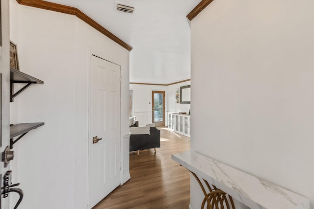 hall with crown molding and wood-type flooring