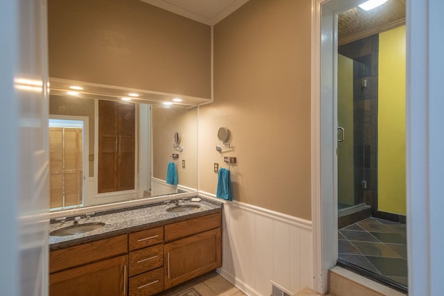 bathroom with tile patterned flooring, vanity, walk in shower, and ornamental molding