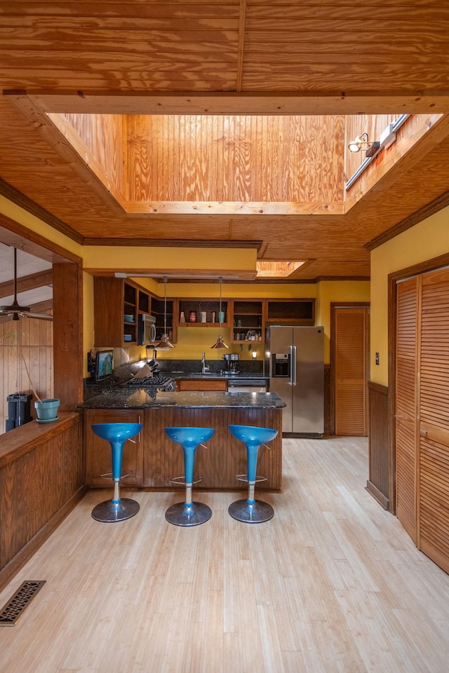 bar with wooden ceiling, light hardwood / wood-style floors, wooden walls, and stainless steel appliances