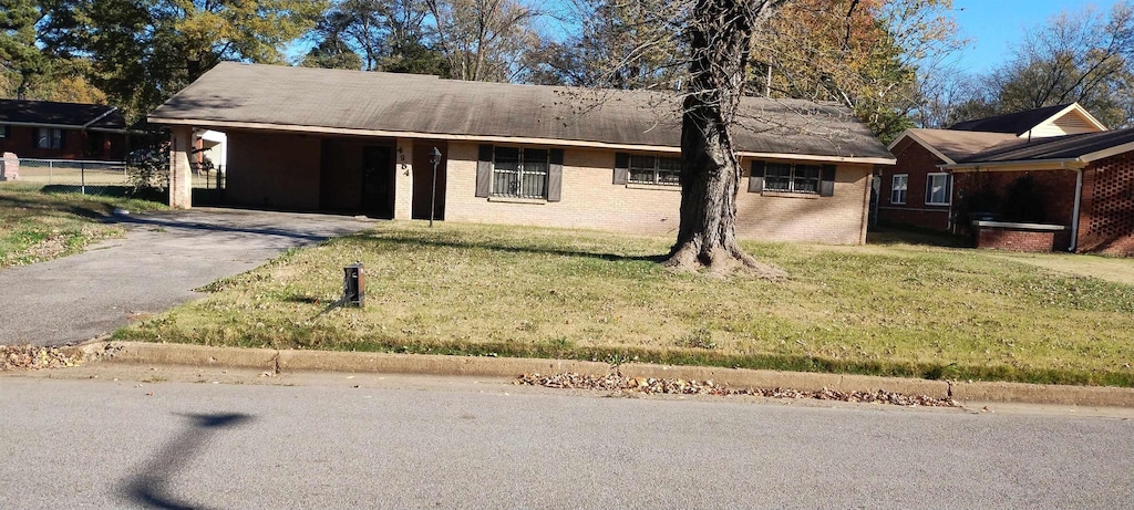 ranch-style house with a front lawn and a carport