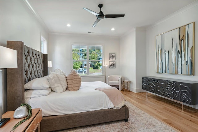 bedroom featuring ceiling fan, crown molding, and wood-type flooring