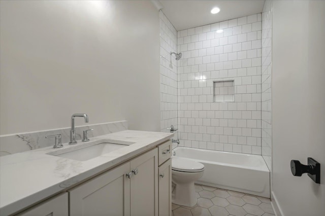 full bathroom featuring tiled shower / bath combo, toilet, tile patterned flooring, and vanity