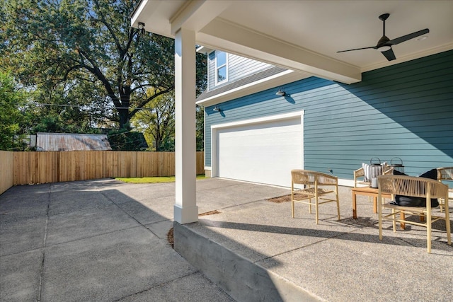 view of patio / terrace with ceiling fan and a garage