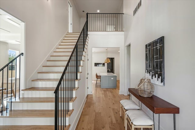 stairway with hardwood / wood-style flooring