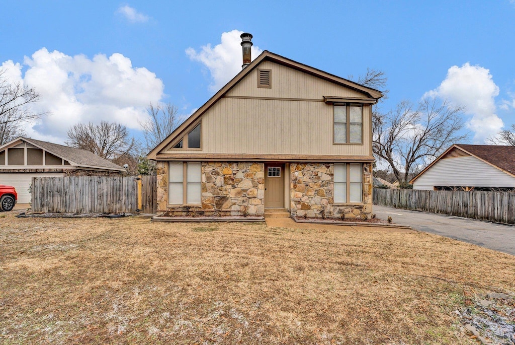 back of property featuring a yard