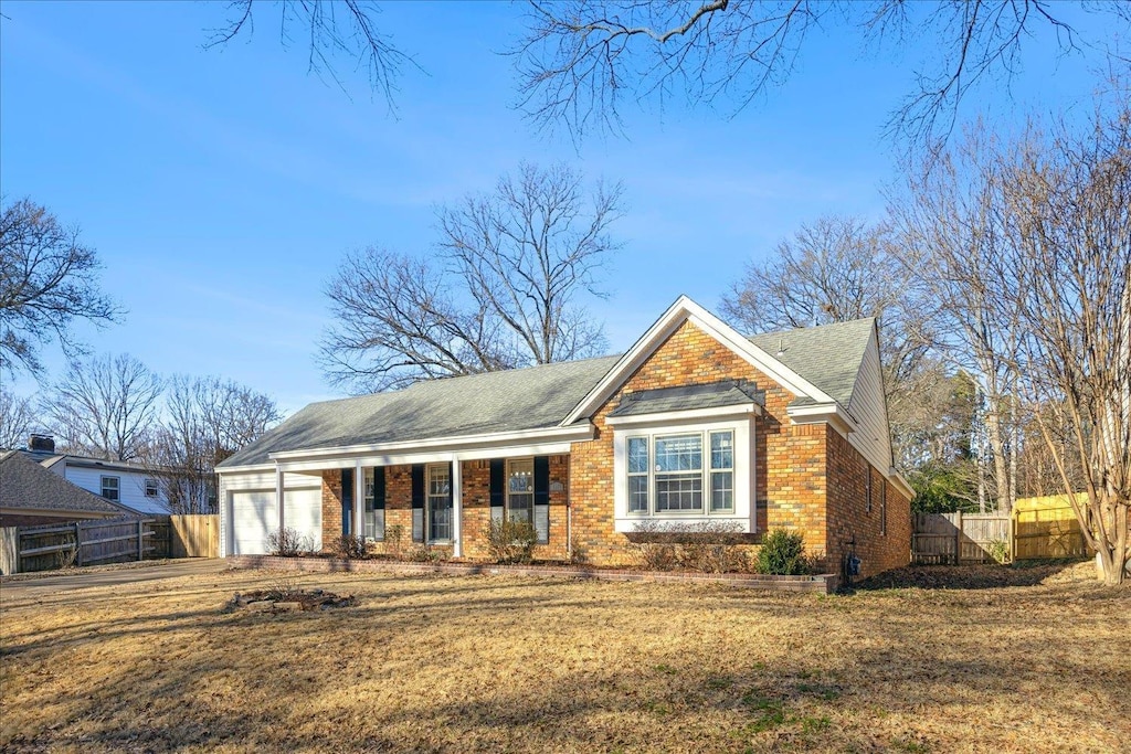 view of front of home with a porch, a garage, and a front yard