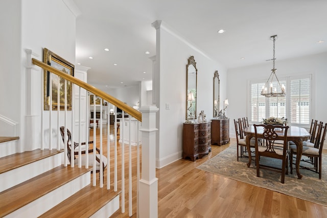 dining room featuring ornamental molding, a notable chandelier, and light wood-type flooring