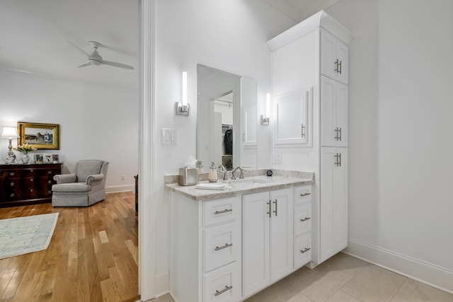 bathroom with ceiling fan, vanity, and tile patterned flooring