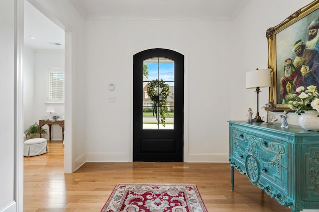 entryway featuring light hardwood / wood-style flooring and ornamental molding