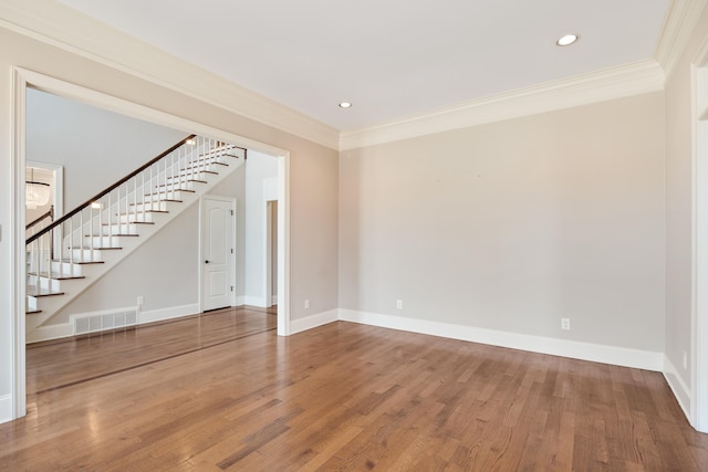 unfurnished living room with crown molding and hardwood / wood-style floors